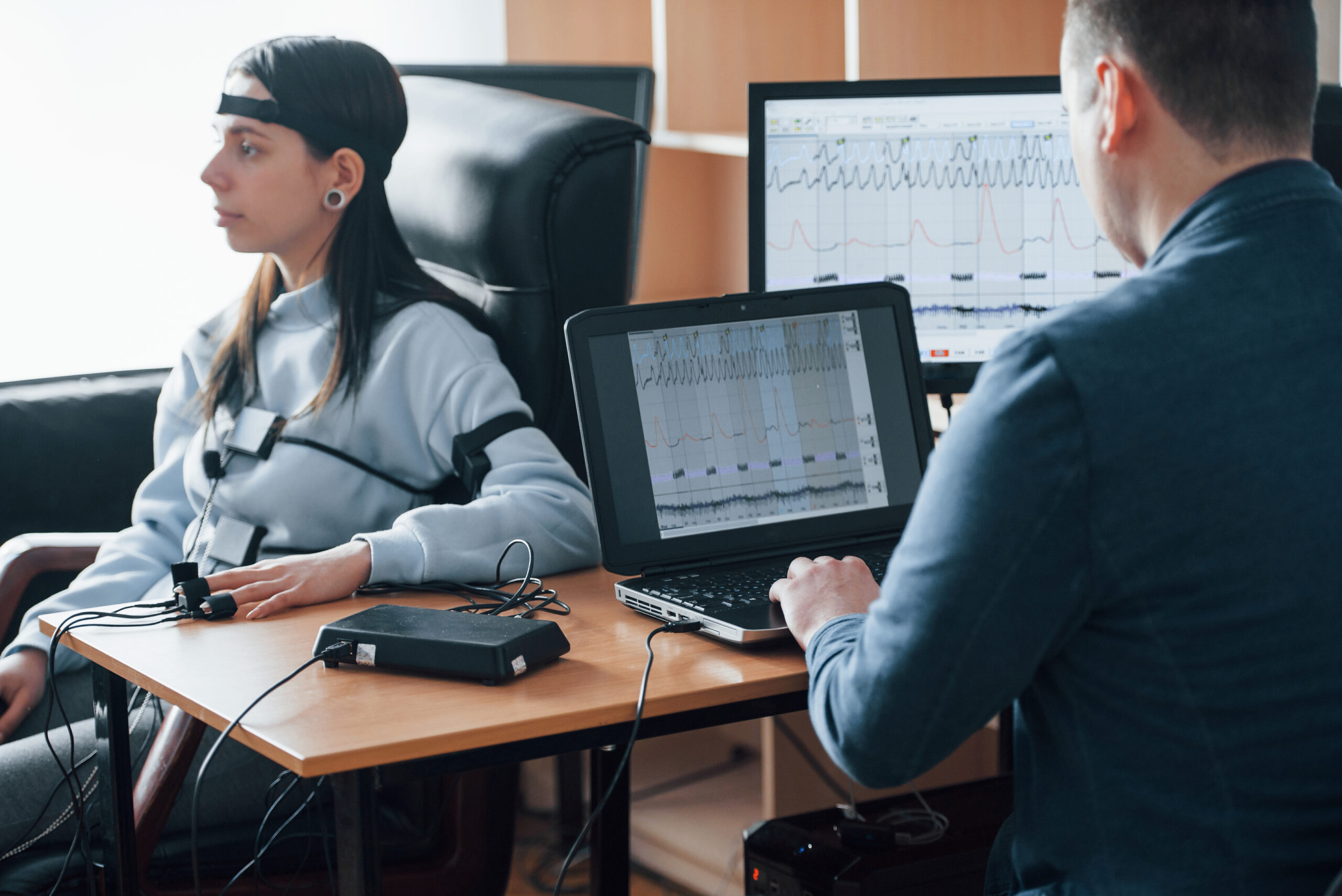 Testing wife for fidelity. Girl passes lie detector in the office. Asking questions. Polygraph test.