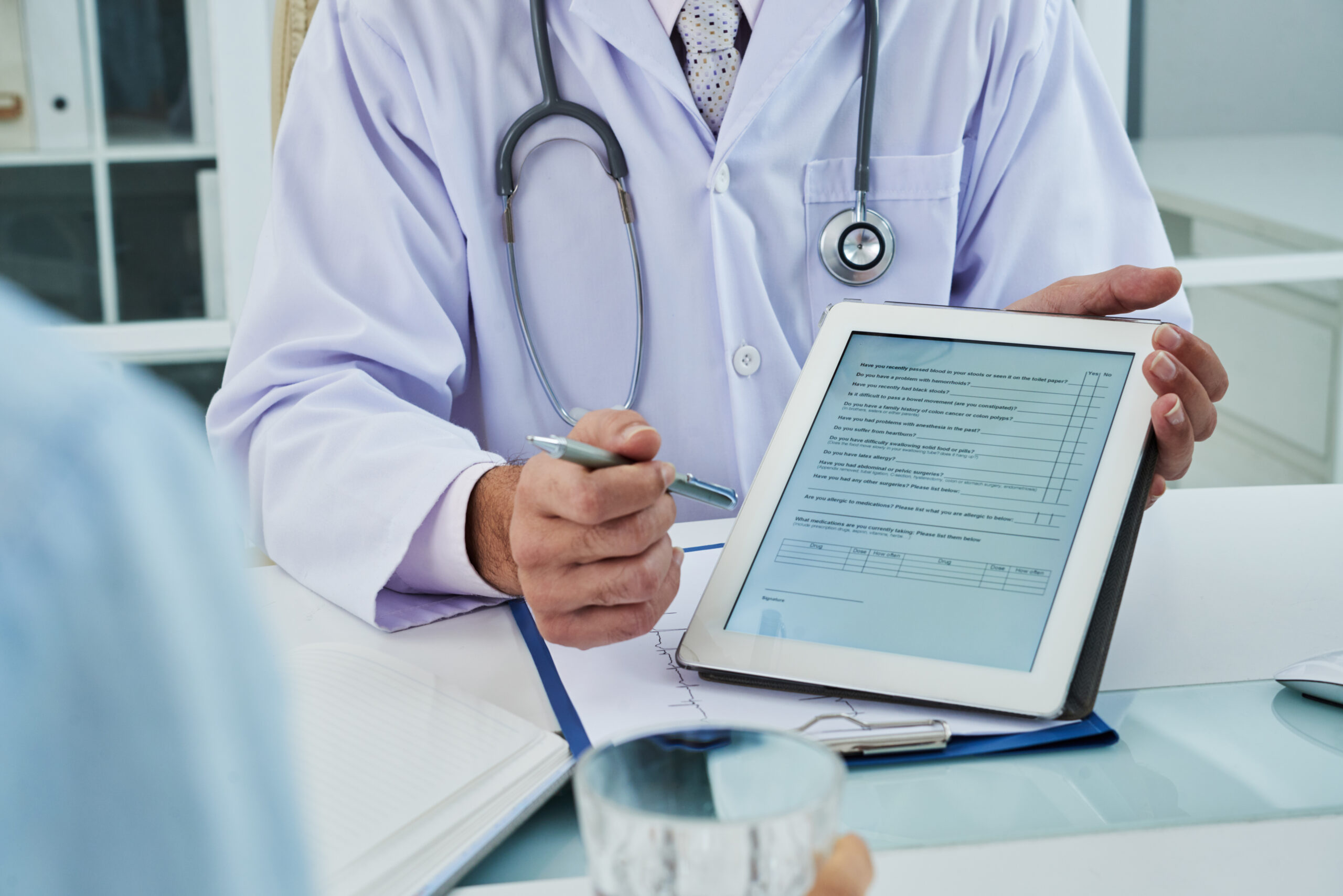 Doctor asking patient to fill the survey before medical treatment