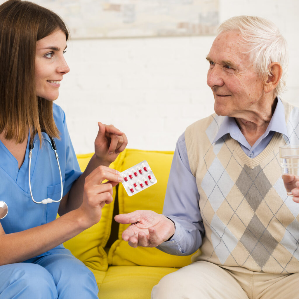 nurse-giving-old-man-his-pills - Medical Service - Phlox Elementor WordPress Theme Elderly Care at Home